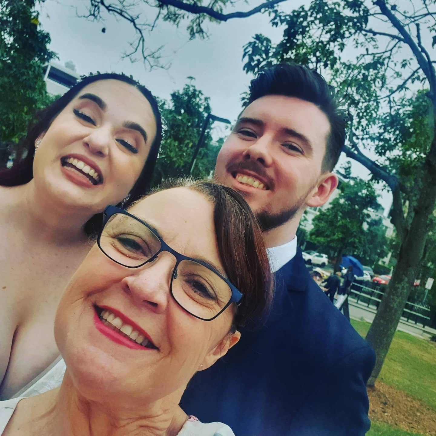 Celebrant with bride and groom outdoors